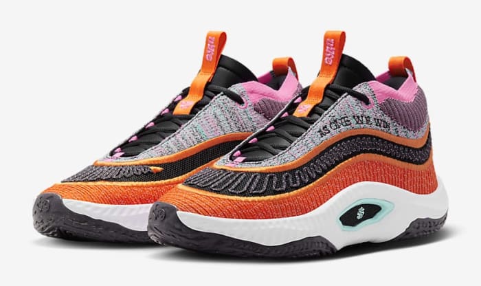 Side view of orange and black Nike shoes.